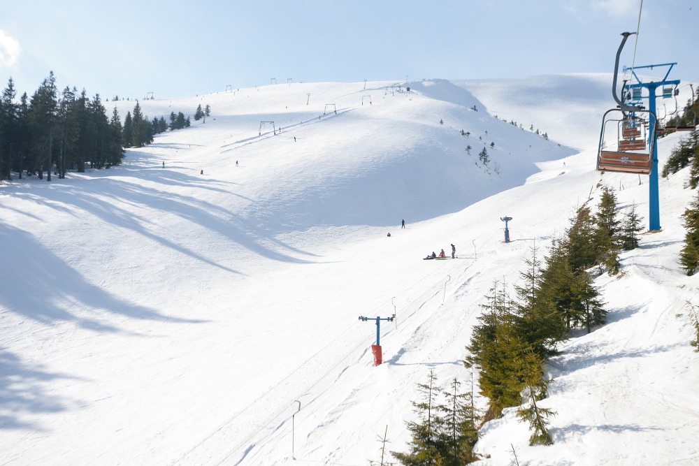 ski-piste-chair-lift-with-snow-covered-trees-sunny-day-combloux-ski-area-french-alps