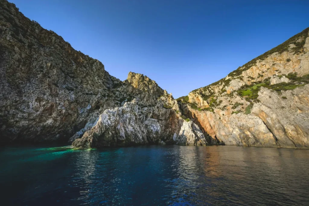 Stunning view of rocky cliffs and tranquil waters in Sardegna, Italy.