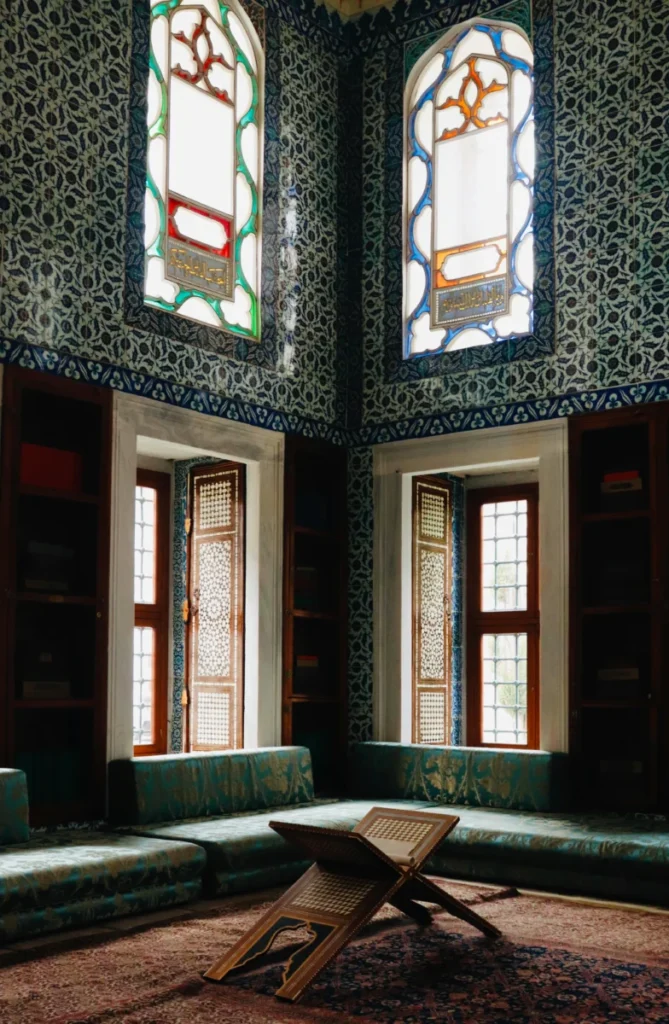 Elegant Ottoman-style room with vibrant stained glass windows in Topkapi Palace Museum, Istanbul.