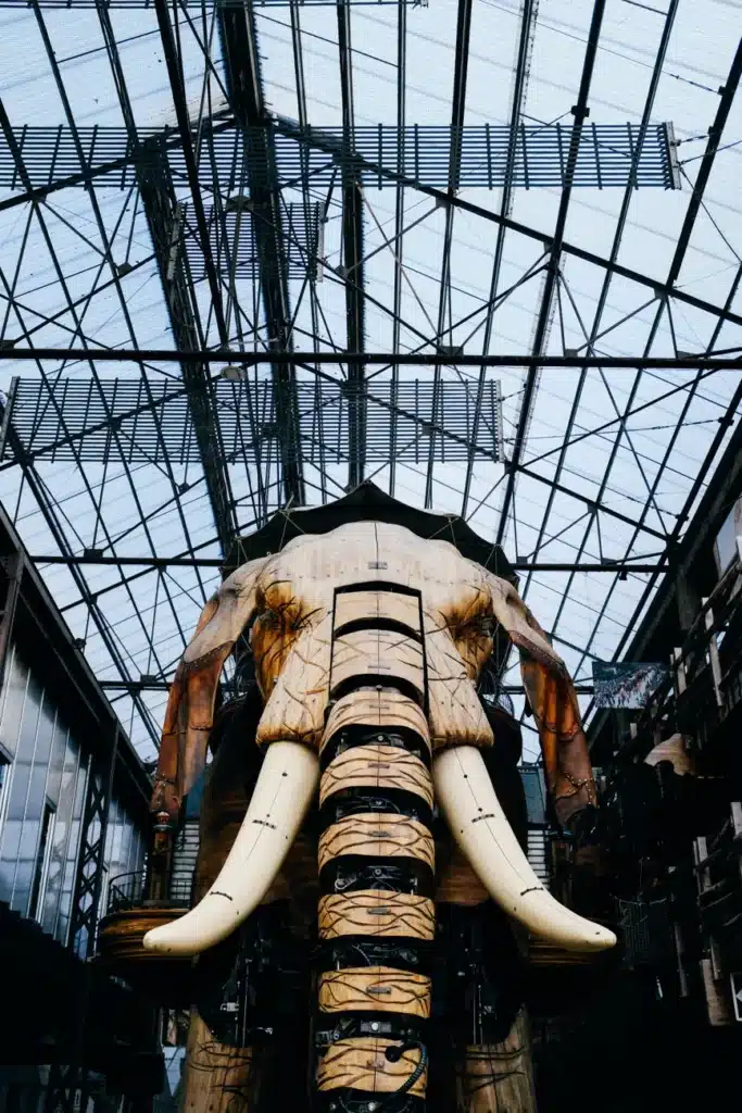 A mechanical elephant sculpture located indoors in an industrial-style museum.