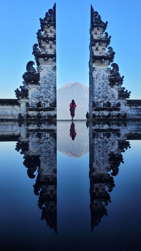 A stunning symmetrical reflection at Pura Lempuyang Temple in Bali, showcasing serene architecture and mountain views.