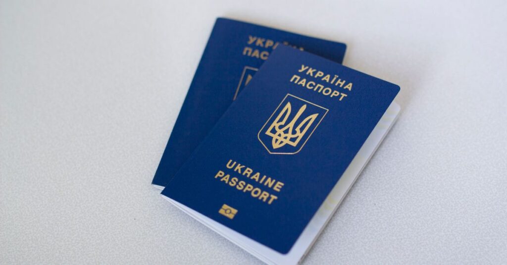 Inde en couple : le guide concret de l’e-visa (et comment bâtir un séjour cohérent sans stress) Blue Ukrainian passports on a light surface, highlighting travel documents.