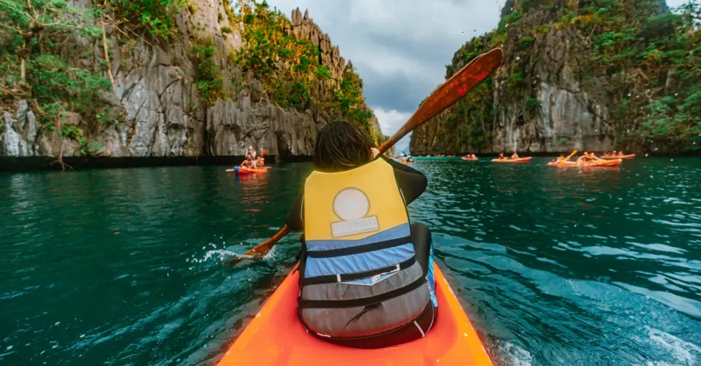 Experience the thrill of kayaking through El Nido's breathtaking limestone formations.
