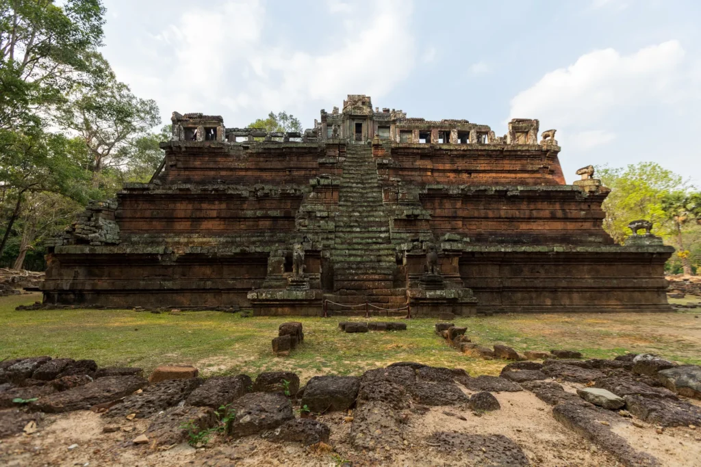 Explore an ancient pyramid-style temple nestled in a serene forest with a bright blue sky overhead.