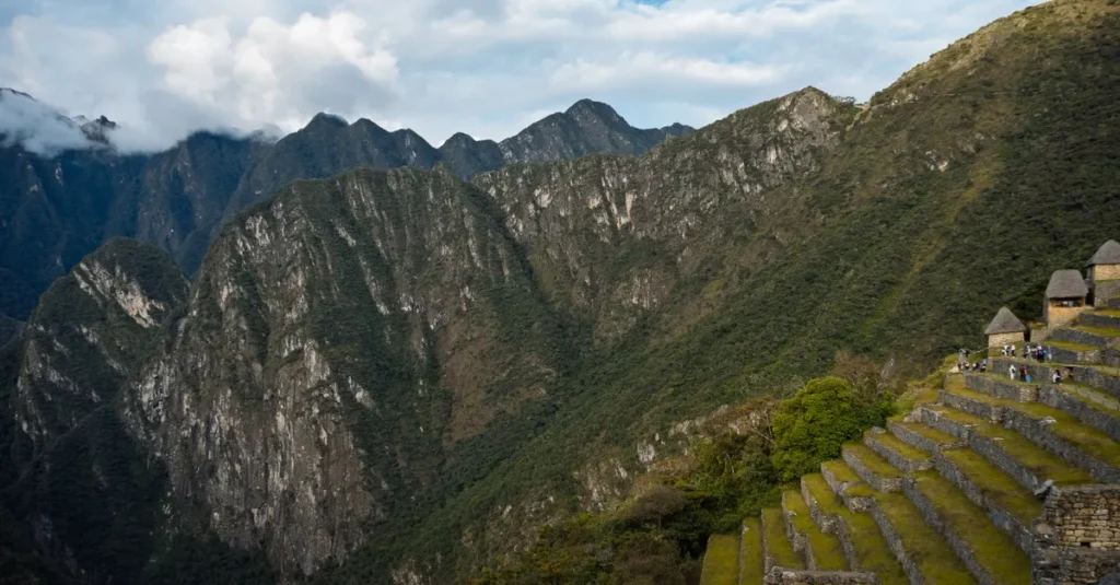 Explore the breathtaking mountain scenery of Machu Picchu with ancient terraces and lush greenery.