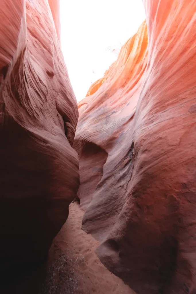 Explore the stunning curves of an eroded slot canyon, showcasing nature's artistry in vibrant sandstone formations.