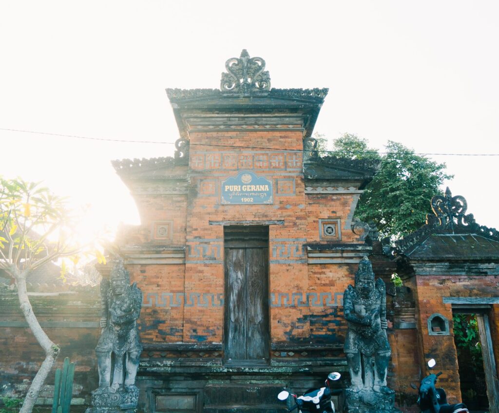 Exploring the historic Puri Gerana temple entrance glowing in the morning sun.