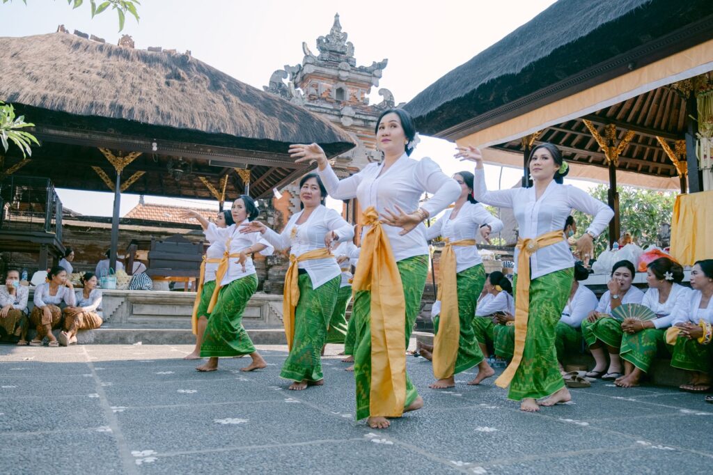 Group of women performing traditional Balinese dance at a temple in Bali, Indonesia.