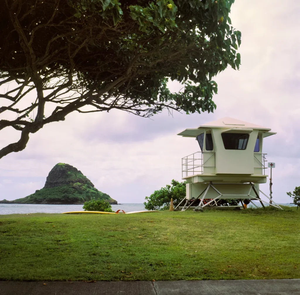 Lifeguard tower near the scenic Chinaman's Hat island on a cloudy day.