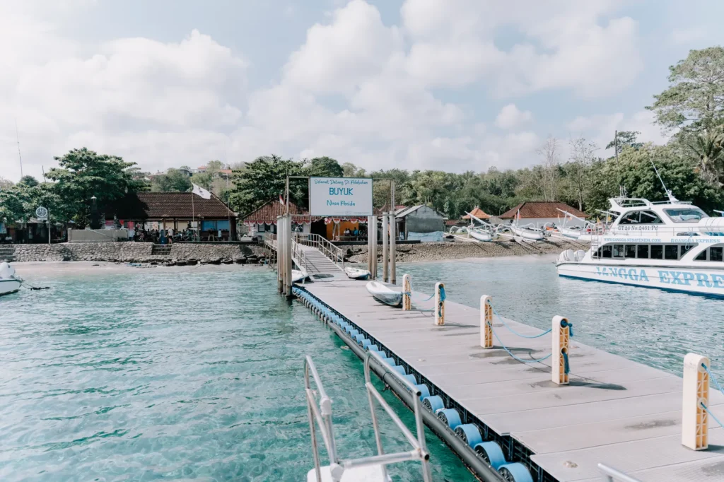 Serene view of Buyuk Pier with clear waters and boats docked, Nusa Penida, Indonesia.