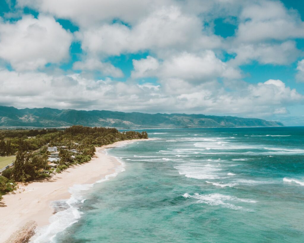 Stunning aerial view of North Shore, Oahu, showcasing its pristine beach and turquoise ocean.