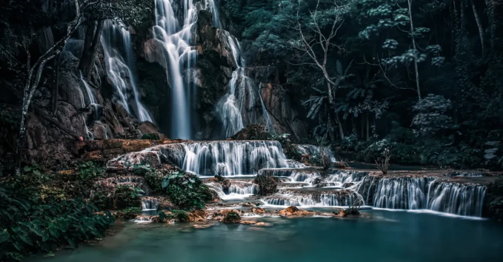 Stunning view of Kuang Si Waterfall in Laos captured in lush green surroundings.