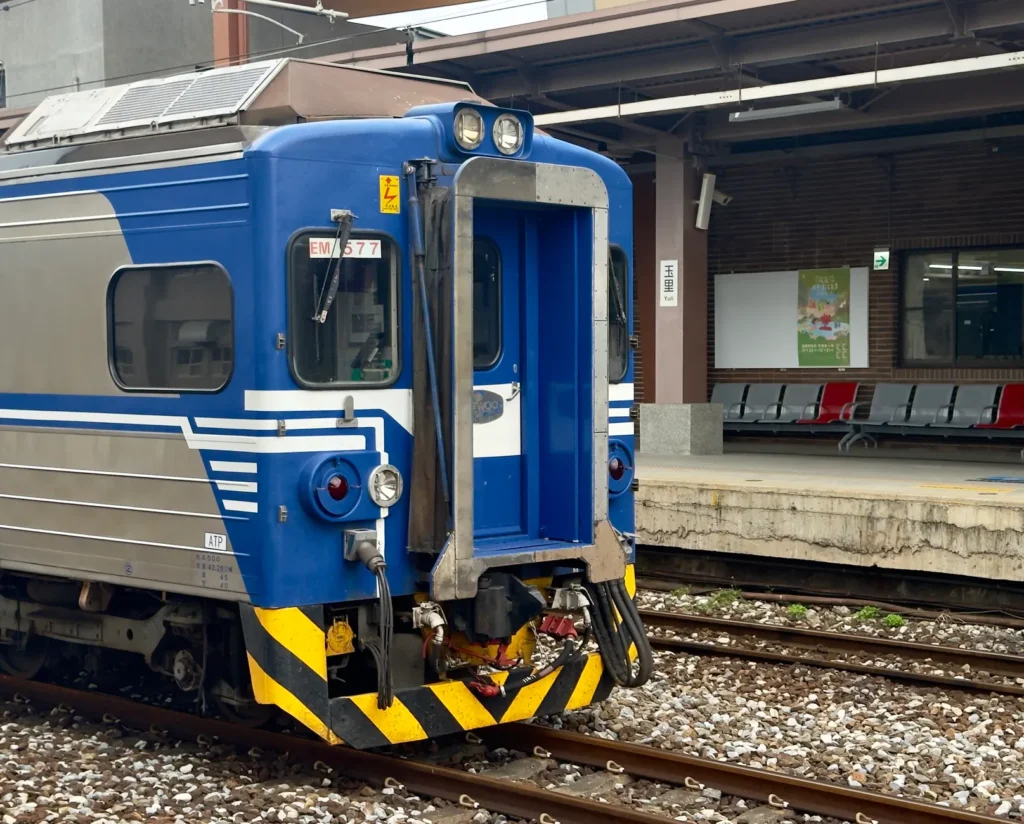 A blue passenger train parked at Hualien Train Station in Taiwan captured during the day.