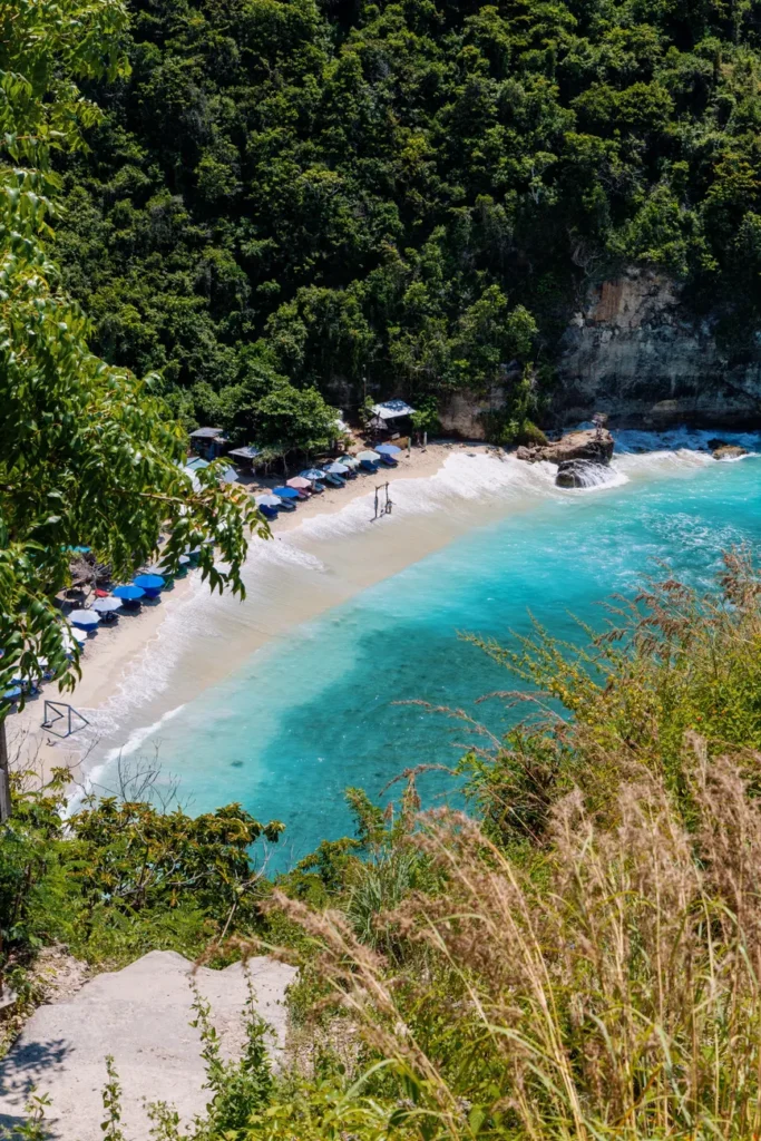 A breathtaking aerial shot of Nusa Penida's beach with turquoise waters and lush greenery.