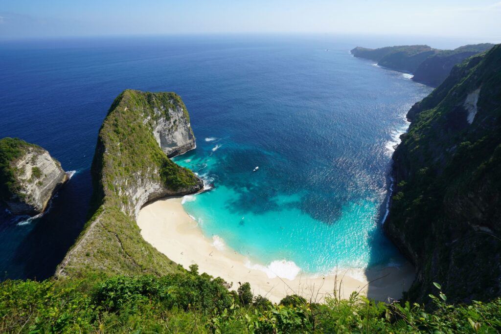 A breathtaking aerial view of the iconic Kelingking Beach on Nusa Penida, Bali, Indonesia.