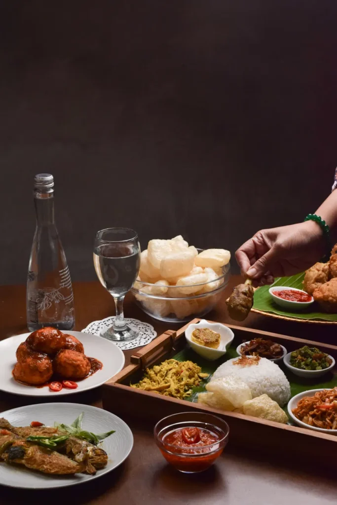 A delicious assortment of traditional Indonesian dishes elegantly presented indoors in Jakarta.