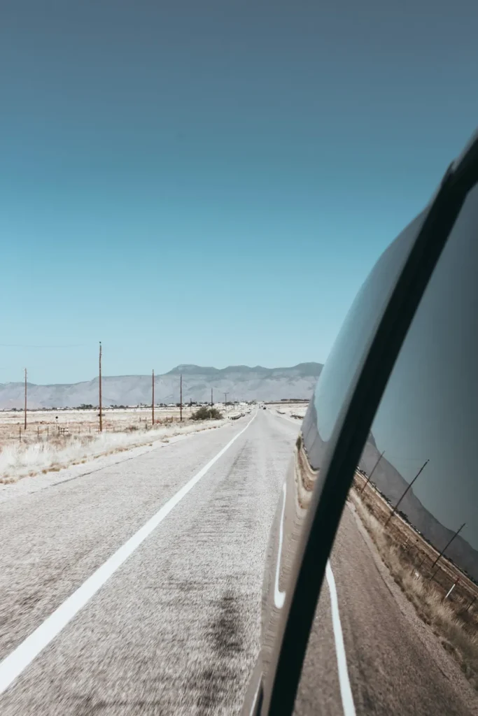 A scenic drive along a desert highway in Arizona captured from a car side mirror.