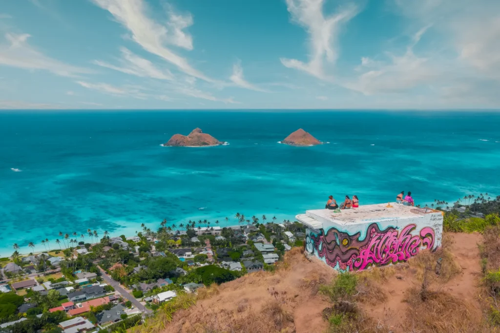 Beautiful aerial view of Lanikai Beach with vibrant ocean and graffiti-covered viewpoint in Hawaii.