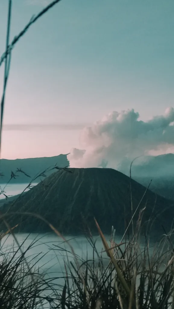 Capture the ethereal beauty of Mount Bromo at sunrise with clouds and stunning landscape.