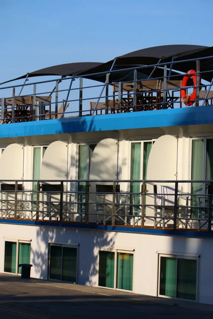 Close-up of a sunlit houseboat deck showcasing stylish outdoor furniture and design.