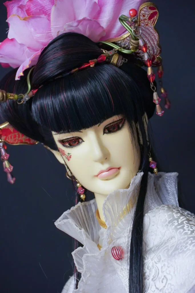 Close-up shot of a beautifully decorated doll with a floral headpiece against a black background.