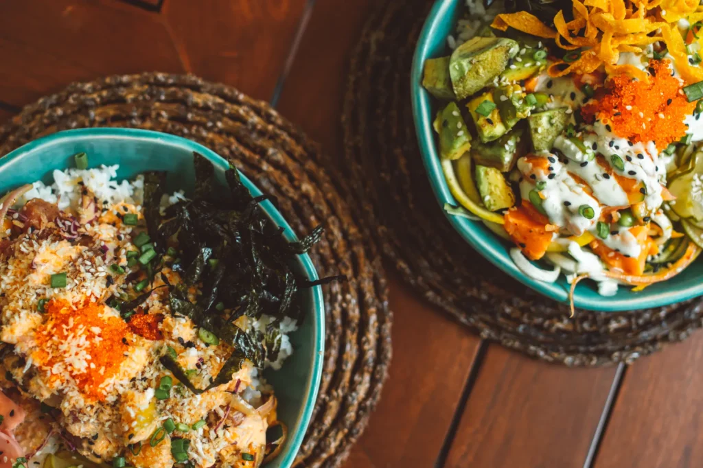 Colorful bowls with fresh sushi and poke ingredients, perfect for lunch or dinner.