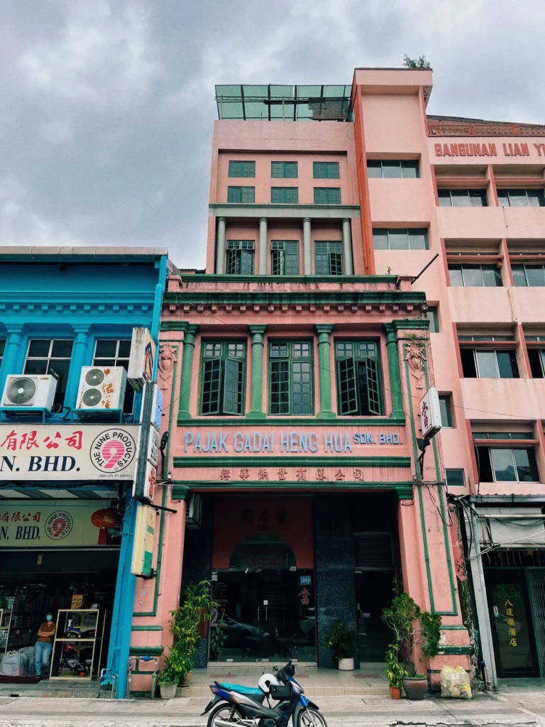 Colorful old town facades on a street in Kuala Lumpur, showcasing vintage architecture.