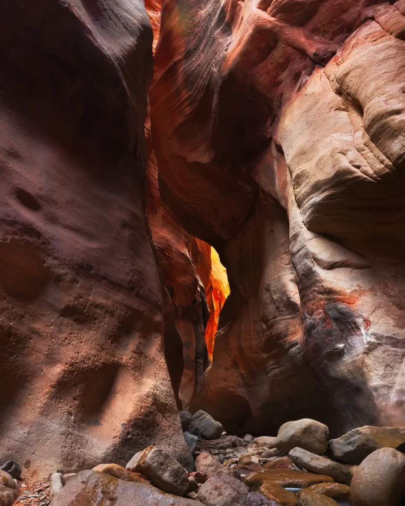Colorful rock formations and narrow passage in Kanarraville Slot Canyon, Utah.