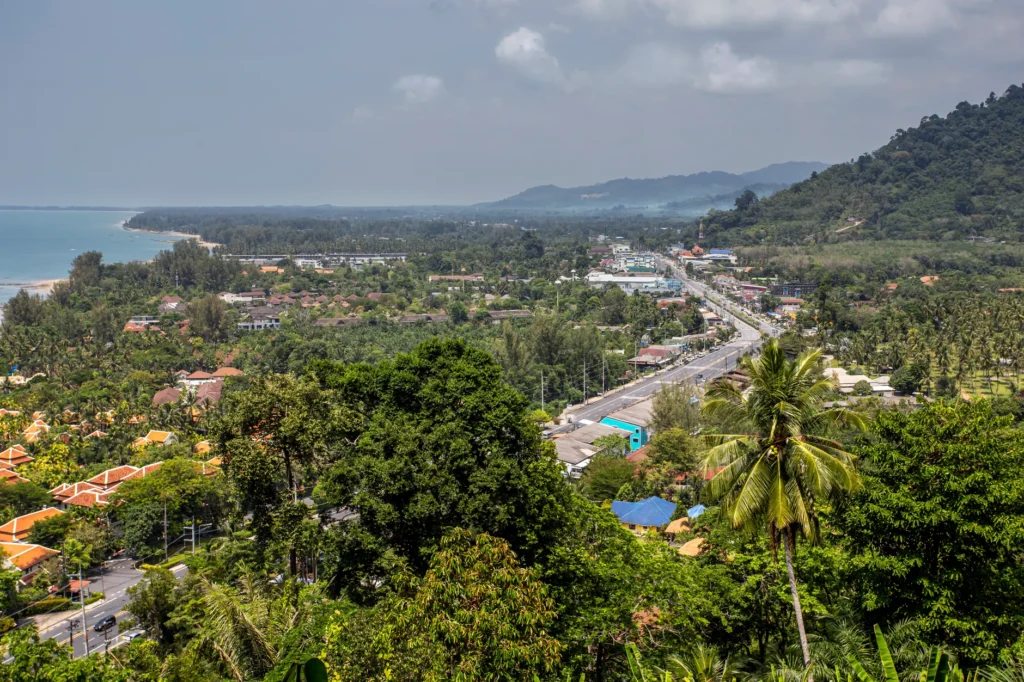 Discover the lush beauty of Phang-nga, Thailand, with its tropical beach, mountains, and vibrant town.