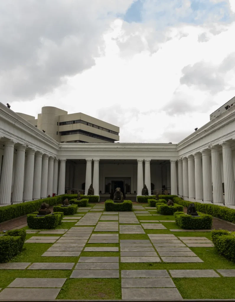 Elegant neoclassical courtyard with columns and greenery in Jakarta, Indonesia.