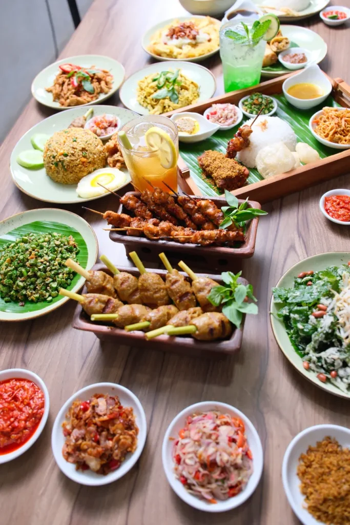 Explore a vibrant display of Indonesian cuisine featuring satay, fried rice, and more.