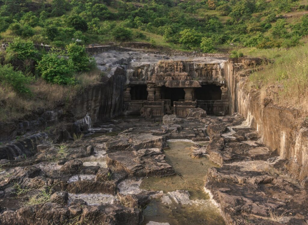 Explore the majestic Ellora Caves carved into the rocky hillside in Maharashtra, India.