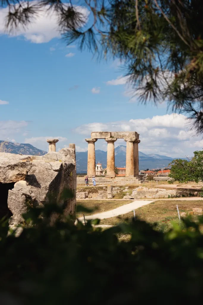 Explore the timeless beauty of ancient Greek temple ruins in sunny Corinth, Greece.