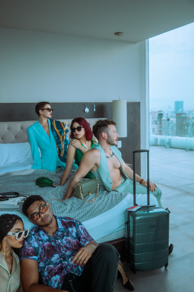 Fashionable group relaxing indoors with city view in Ciudad de México hotel room, highlighting modern style and togetherness.