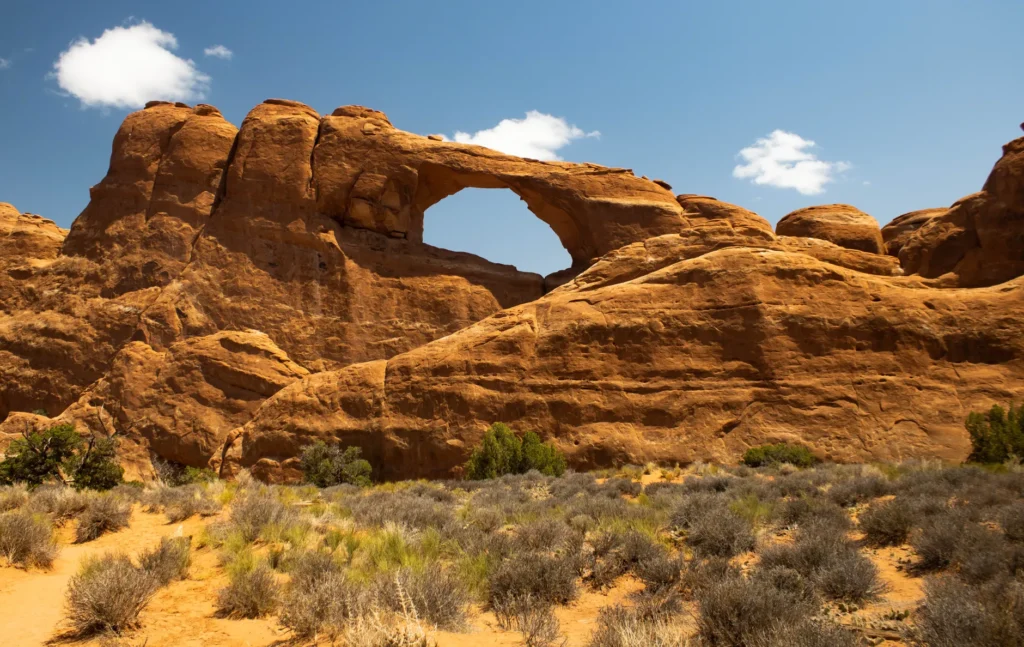 Majestic view of Skyline Arch in Arches National Park, Utah, showcasing natural rock formations under a clear blue sky.
