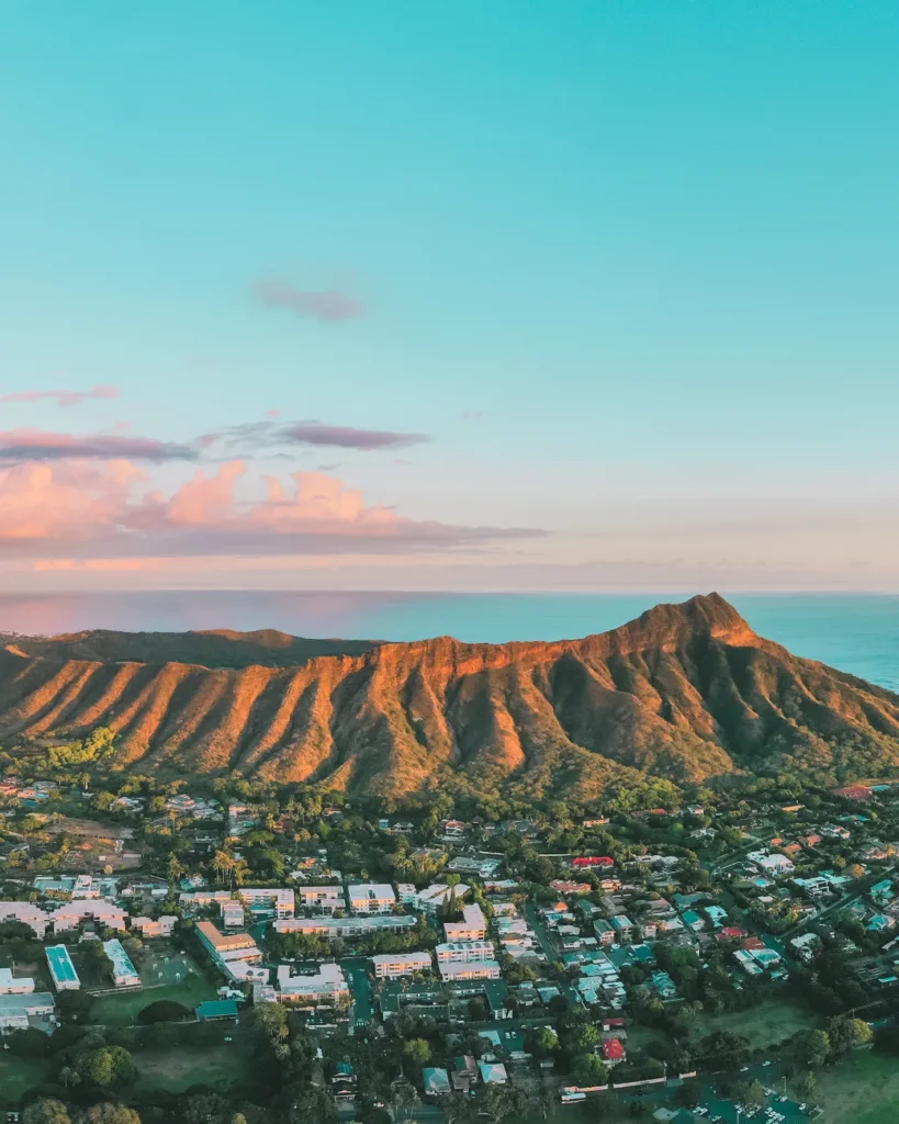 Scenic aerial view of Diamond Head crater with Honolulu suburb at twilight.