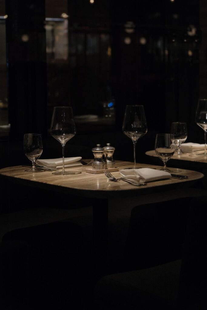 Sophisticated table setup in a New York restaurant, with wine glasses and cutlery, ready for a gourmet experience.