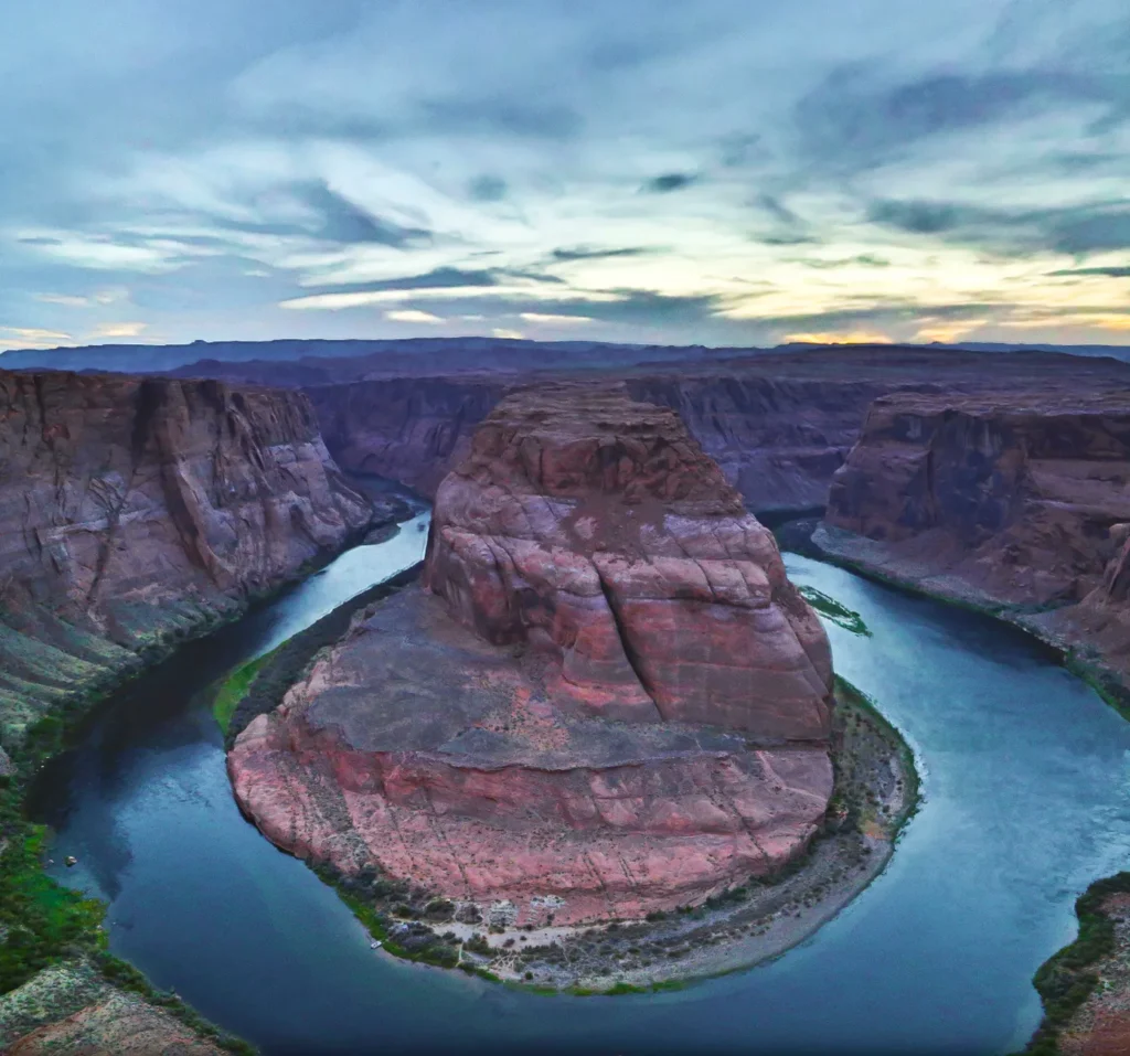 Stunning aerial capture of Horseshoe Bend, Arizona at sunset with vibrant sky and river curve.
