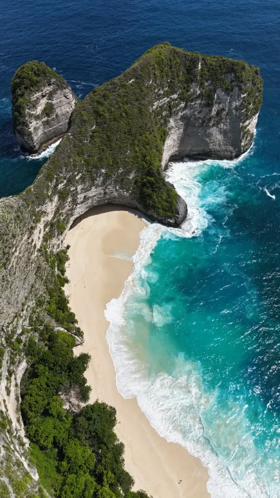 Stunning aerial shot of Kelingking Beach, showcasing the turquoise waters and iconic cliff of Nusa Penida, Bali.