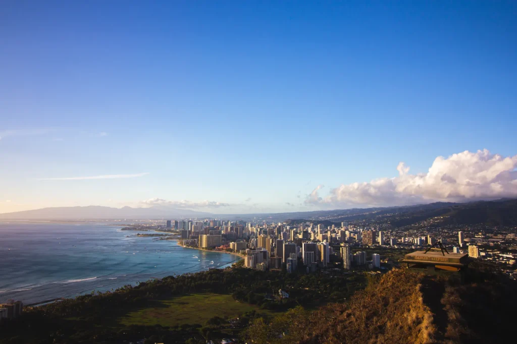Stunning aerial view of Honolulu cityscape from Diamond Head, showcasing the Pacific Ocean.
