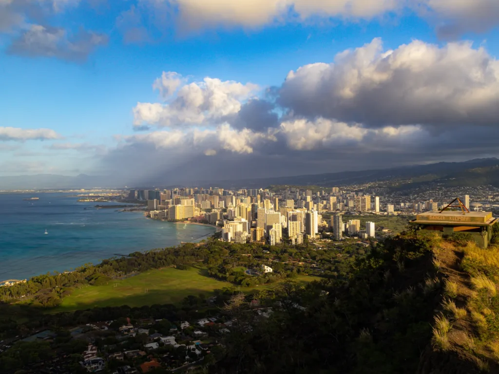 Stunning aerial view of Honolulu skyline and coastline from Diamond Head, Hawaii at sunset.