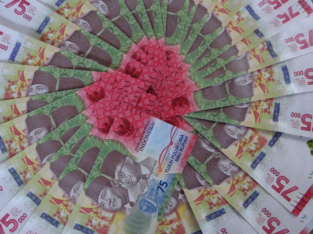 Stunning arrangement of 75,000 Indonesian Rupiah notes showcasing vibrant colors and intricate designs.