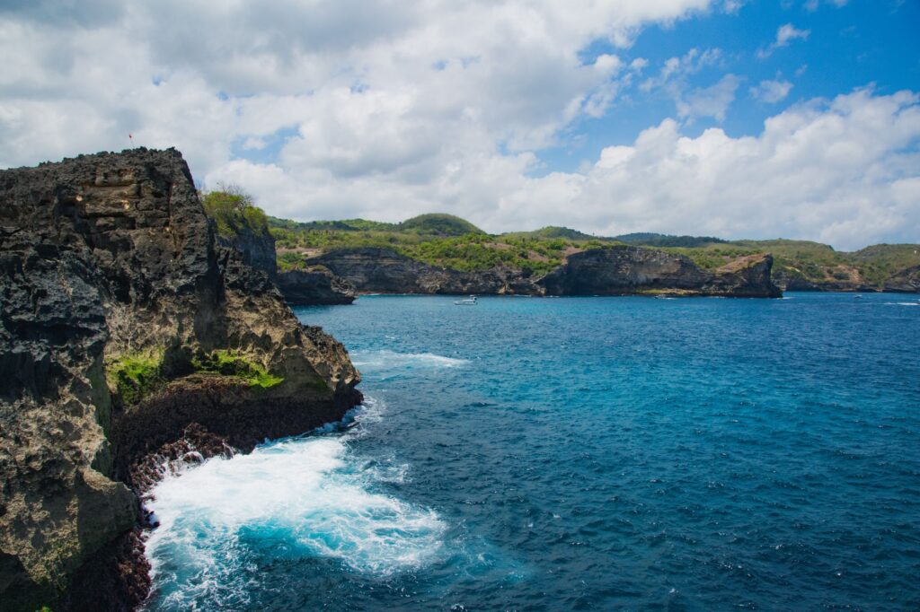 Stunning coastal cliffs and vibrant blue ocean at Nusa Penida, Bali, Indonesia.