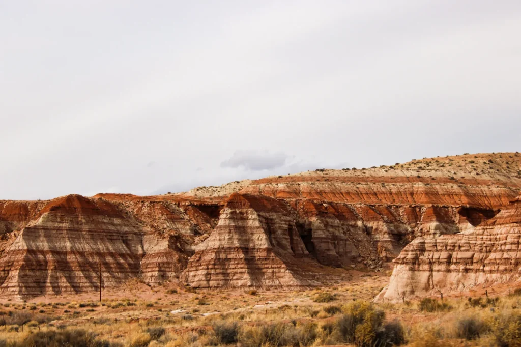 Stunning layered red rock formations in Utah desert landscape under a clear sky.
