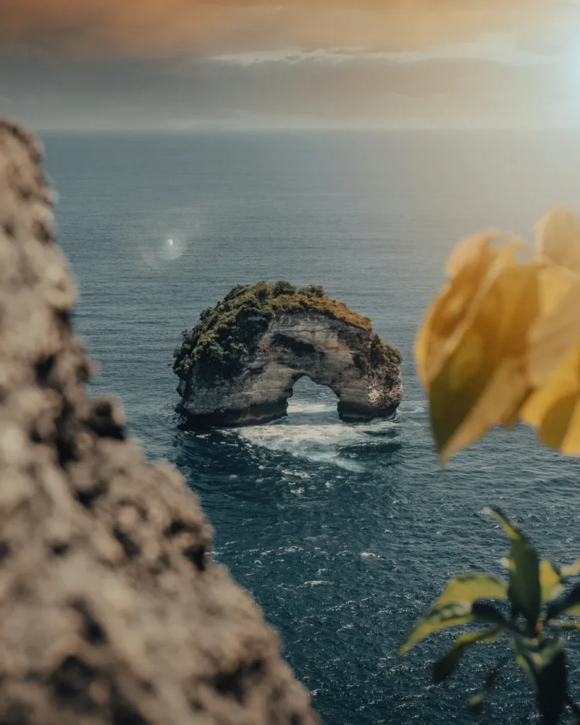 Stunning ocean view of Banah Cliff, Nusa Penida, Bali, showcasing natural beauty and sea arch formation.