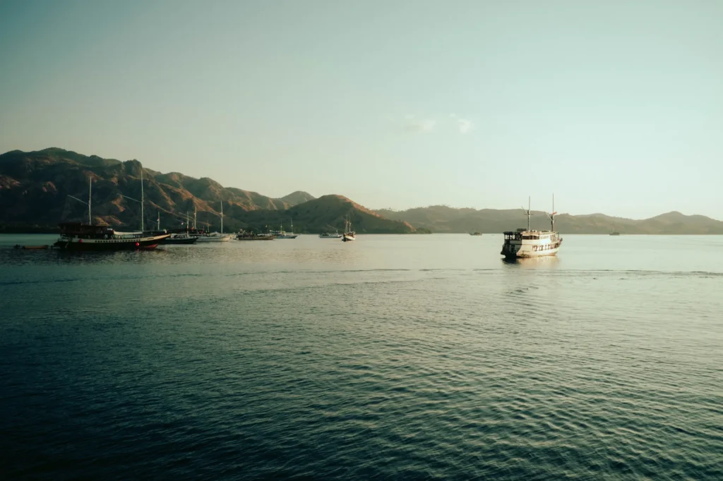 Tranquil scene of boats anchored in the calm waters of Komodo National Park.