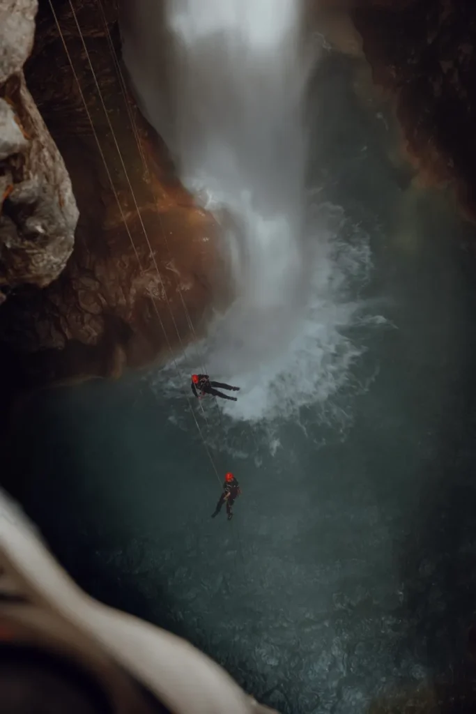 Two people canyoning down a waterfall in Antalya, Türkiye, showcasing adventure and excitement.
