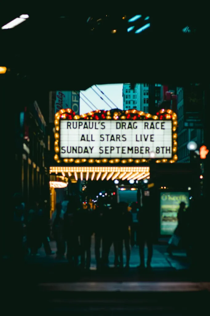 Vibrant Chicago theater marquee at night, showcasing urban nightlife and architecture.