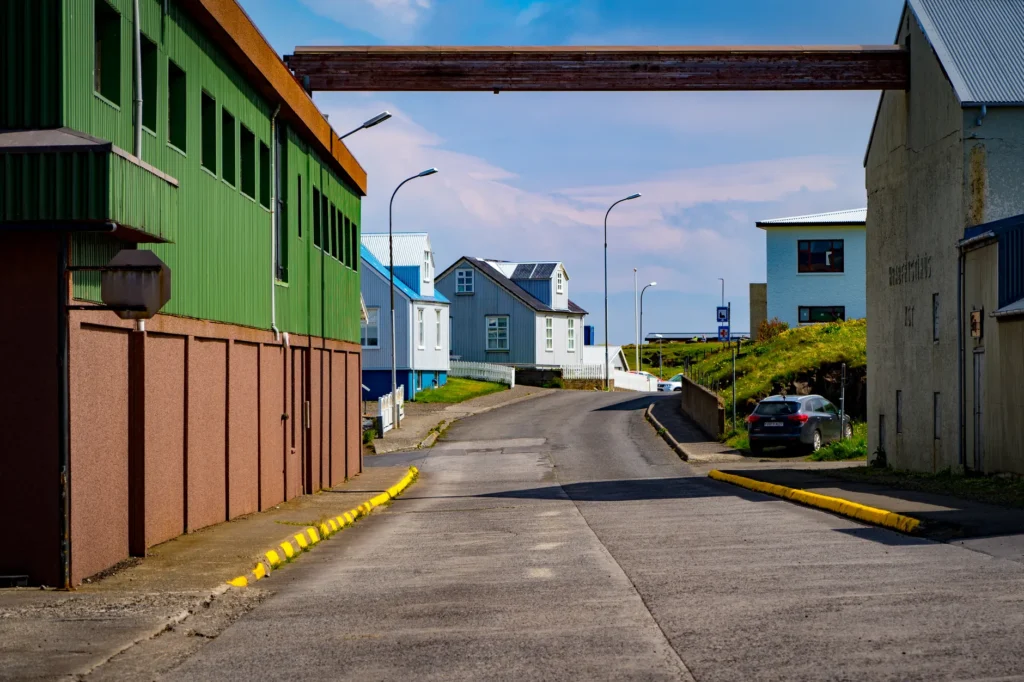 Vibrant street view in a colorful Icelandic town on a sunny day, showcasing unique architecture.