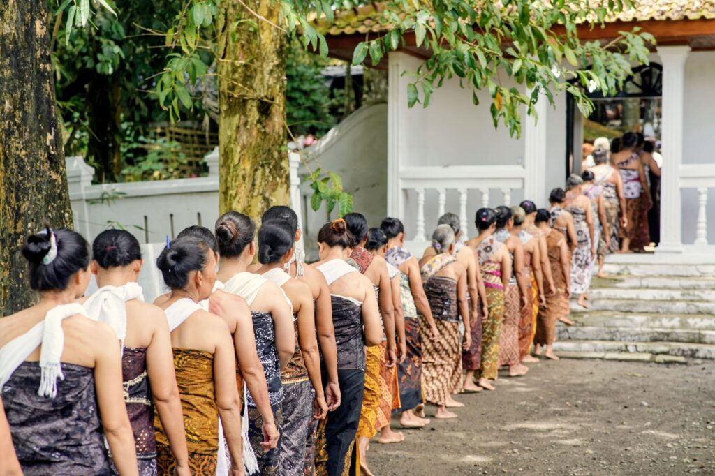 A group of Javanese women in traditional attire participate in a cultural procession in Central Java.